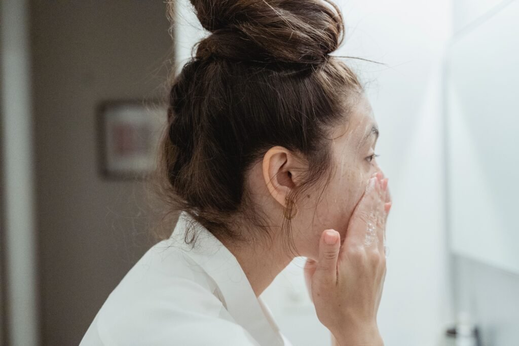 Woman applying natural skincare products for glowing skin